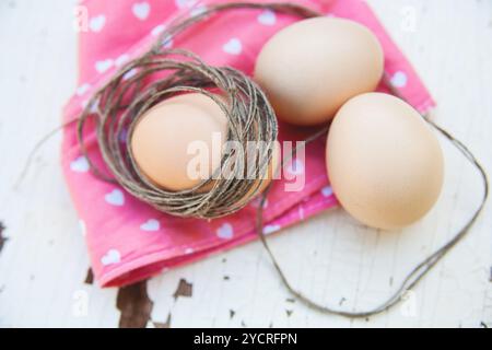 Top view of three eggs on rose napkin close up Stock Photo