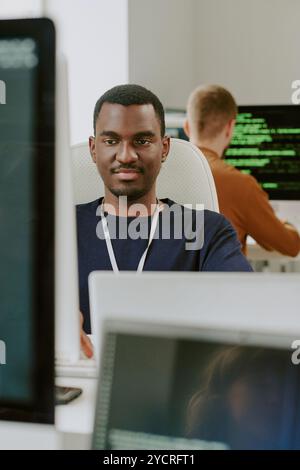 Young Black Man Working In IT Company Office Stock Photo