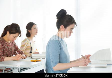 Female university students taking classes Stock Photo