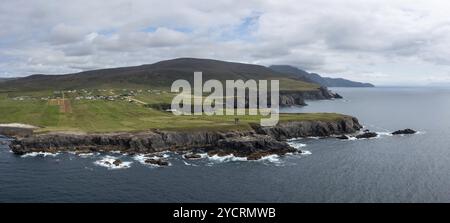 Aerial panorama view of the rugged coastline of County Donegal at Malin Beg with the ruins of the Napoleonic signal tower on the cliff edge Stock Photo