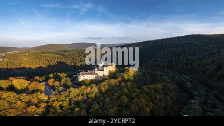 Lockenhaus, Austria, 7 October, 2022: panorama of Lockenhaus Castle surrounded by autumn forest in warm evening light, Europe Stock Photo