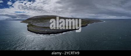 An aerial view of the Burren Coast in County Clare with the Black Head Lighthouse on the rocky point Stock Photo