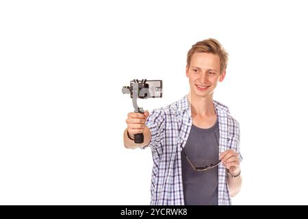 Man holds small action camera on gimbal. Stock Photo