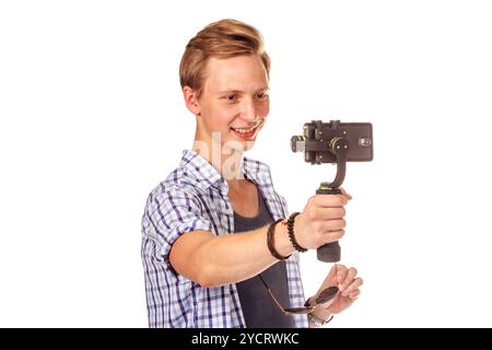 Man holds small action camera on gimbal. Stock Photo