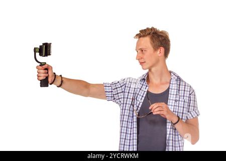 Man holds small action camera on gimbal. Stock Photo