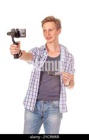 Man holds small action camera on gimbal. Stock Photo