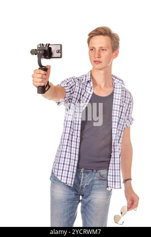 Man holds small action camera on gimbal. Stock Photo