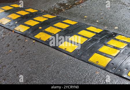 Traffic safety speed bump on an asphalt road Stock Photo