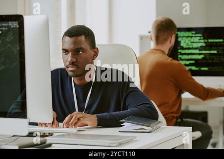 Young Black Man Typing On Computer Stock Photo