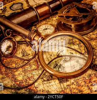 Vintage Compass and magnifying glass lies on an ancient world map ...