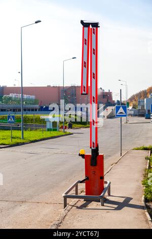 Automatic rising arm barrier for entry or stop traffic. Boom Barrier Stock Photo