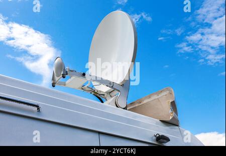 Satellite dish mounted on the roof of mobile television station Stock Photo