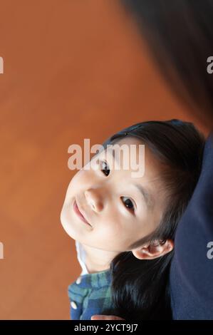 Girl looking up at her mother Stock Photo