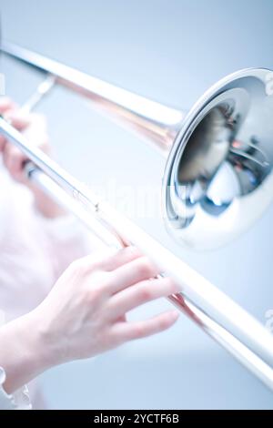 Hand playing trombone Stock Photo