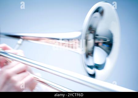 Hand playing trombone Stock Photo