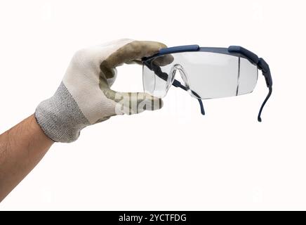 Hand with working glove holding protective glasses. Isolated on white background. Stock Photo