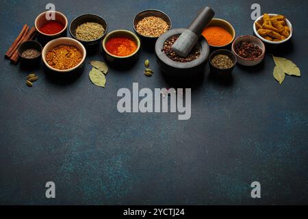 Various spices and herbs in bowls Stock Photo