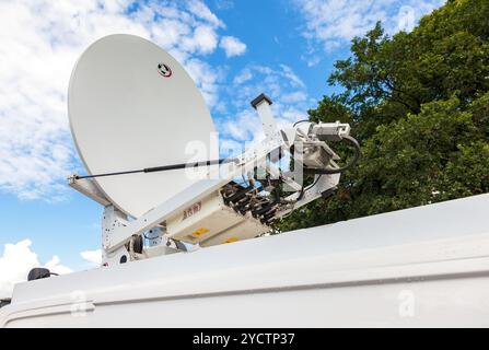 Satellite dish mounted on the roof of mobile television station Stock Photo