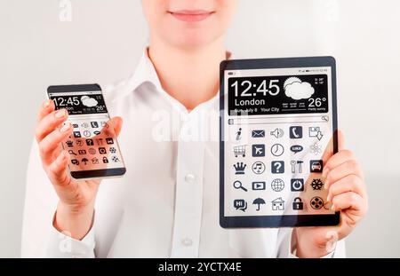 Smartphone and tablet with transparent screen in human hands. Stock Photo