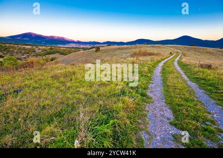 Country road in Lika region landscape Stock Photo