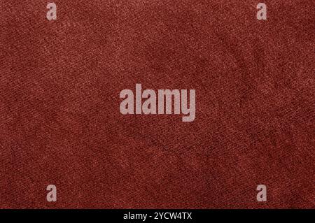 Closeup of a rich red textile, showing a smooth and fine fabric texture. Stock Photo
