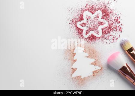 Christmas decorations made of powder and blush near makeup brushes on white background, flat lay. Space for text Stock Photo