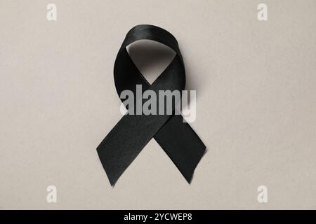 Black awareness ribbon on gray background, top view Stock Photo