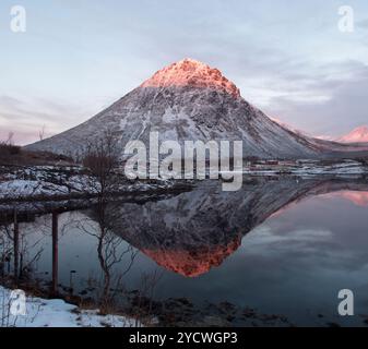 Arctic Norway sun and water reflections, Arctic sunset, glowing pink mountain top Stock Photo