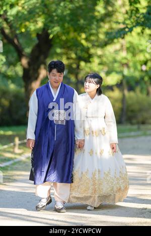 A Korean couple, a man in his 30s and a woman in her 20s, are spending time together in a historic park in Seoul, South Korea. Stock Photo
