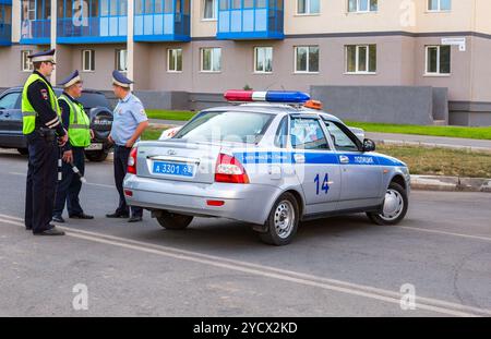 Russian police patrol cars of the State Automobile Inspectorate on the city street in summer day Stock Photo