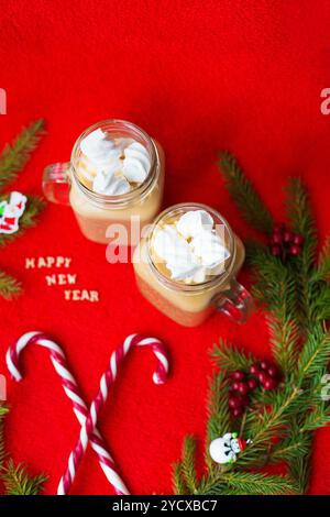 Christmas tree, candy, coffee marshmellou on a red background. The inscription Happy New Year Stock Photo