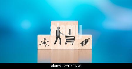 Wooden blocks with symbol of purchase concept on blue background Stock Photo