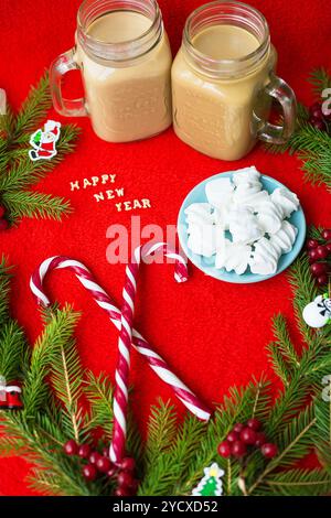 Christmas tree, candy, coffee marshmellou on a red background. The inscription Happy New Year Stock Photo