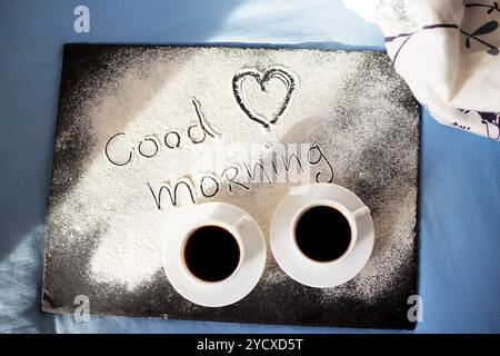 Good morning inscription flour on a board with cups of coffee, heart Valentine's day Stock Photo