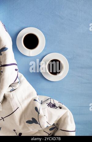Two white cups of coffee are in bed Stock Photo