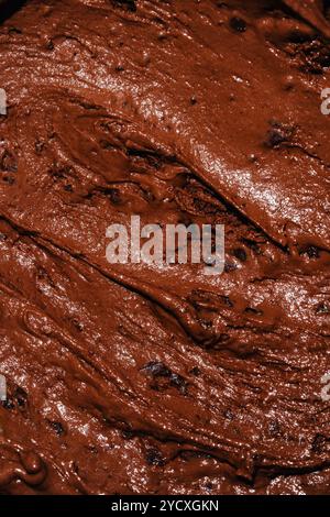A high-resolution image capturing the rich texture of chocolate ice cream, enhanced with scattered chocolate chunks, ideal for showcasing in a cafe se Stock Photo