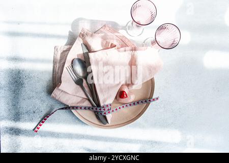 Elegant romantic table setting featuring a heart theme, ideal for Valentine's Day dinners or special occasions The image includes heart-shaped accents Stock Photo