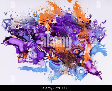 This vibrant artwork features an explosion of ink drops in brilliant shades of purple, blue, and orange, creating a dynamic and abstract composition i Stock Photo