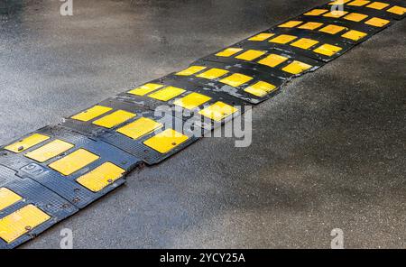 Traffic safety speed bump on an asphalt road Stock Photo