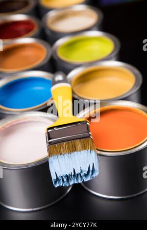 Tin cans with paint and brushes Stock Photo