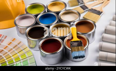 Tin cans with paint and brushes Stock Photo