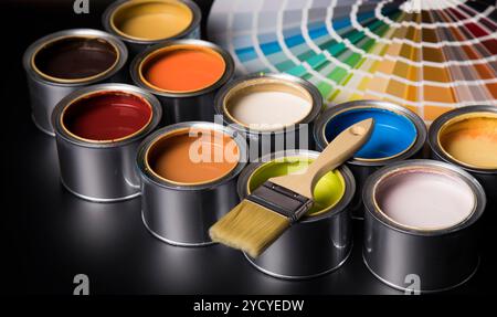 Tin cans with paint and brushes Stock Photo