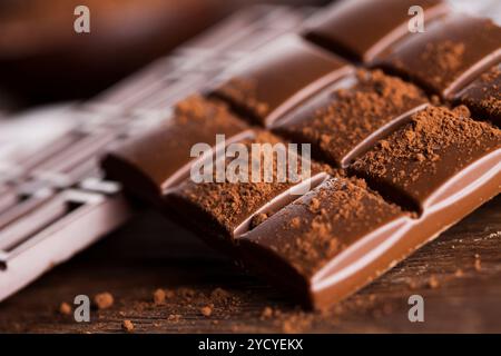 Dark homemade chocolate bars and cocoa pod on wooden Stock Photo