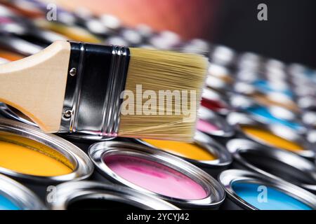 Tin metal cans with color paint and paintbrush Stock Photo