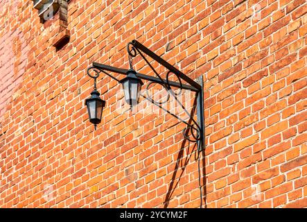 Vintage decorative lantern hanging on an old brick wall Stock Photo