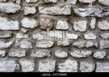 Rough stone wall as creative background texture Stock Photo