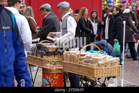 Madrid, Spain; December, 6, 2023: A wafer seller with baskets full of wafers, made from flour, sells this typical sweet at the traditional Christmas m Stock Photo