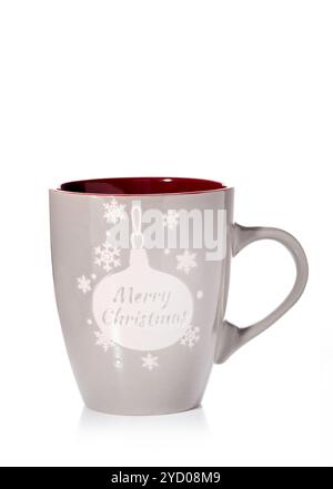 A brown cup with a handle and New Year inscriptions and patterns isolated on a white background. Stock Photo