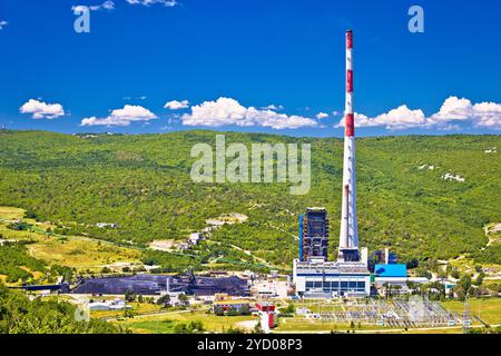 Coal fossil fuel power plant in green Plomin valley and highest croatian chimney view Stock Photo