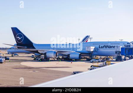 Lufthansa and Air France airplanes parked at airport on sunny day near terminal gates. New York. USA. Stock Photo